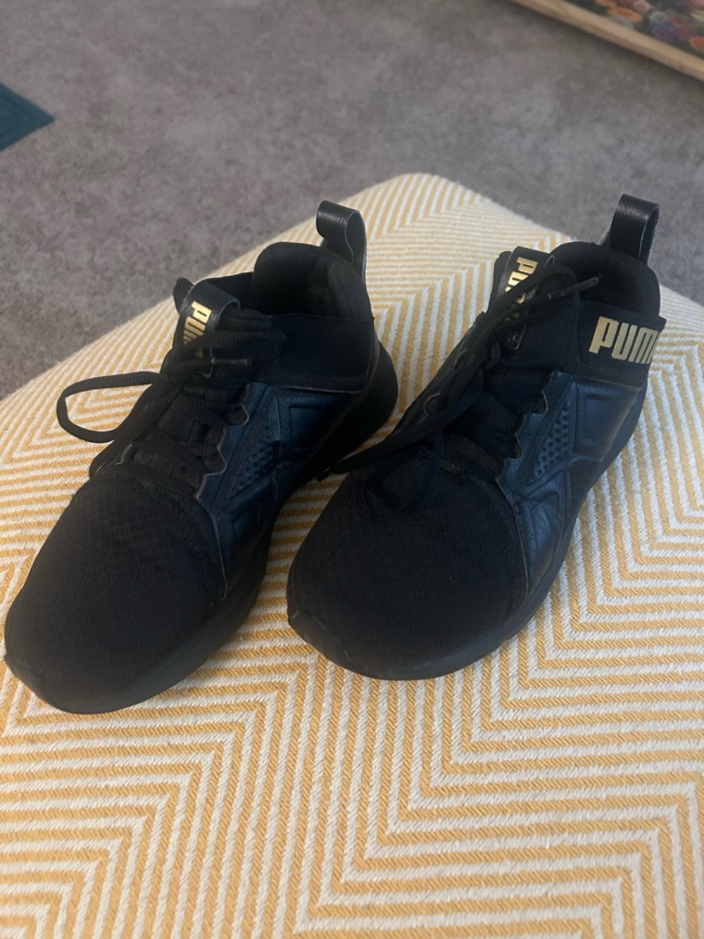 Puma Black Sneakers with Gold Branding